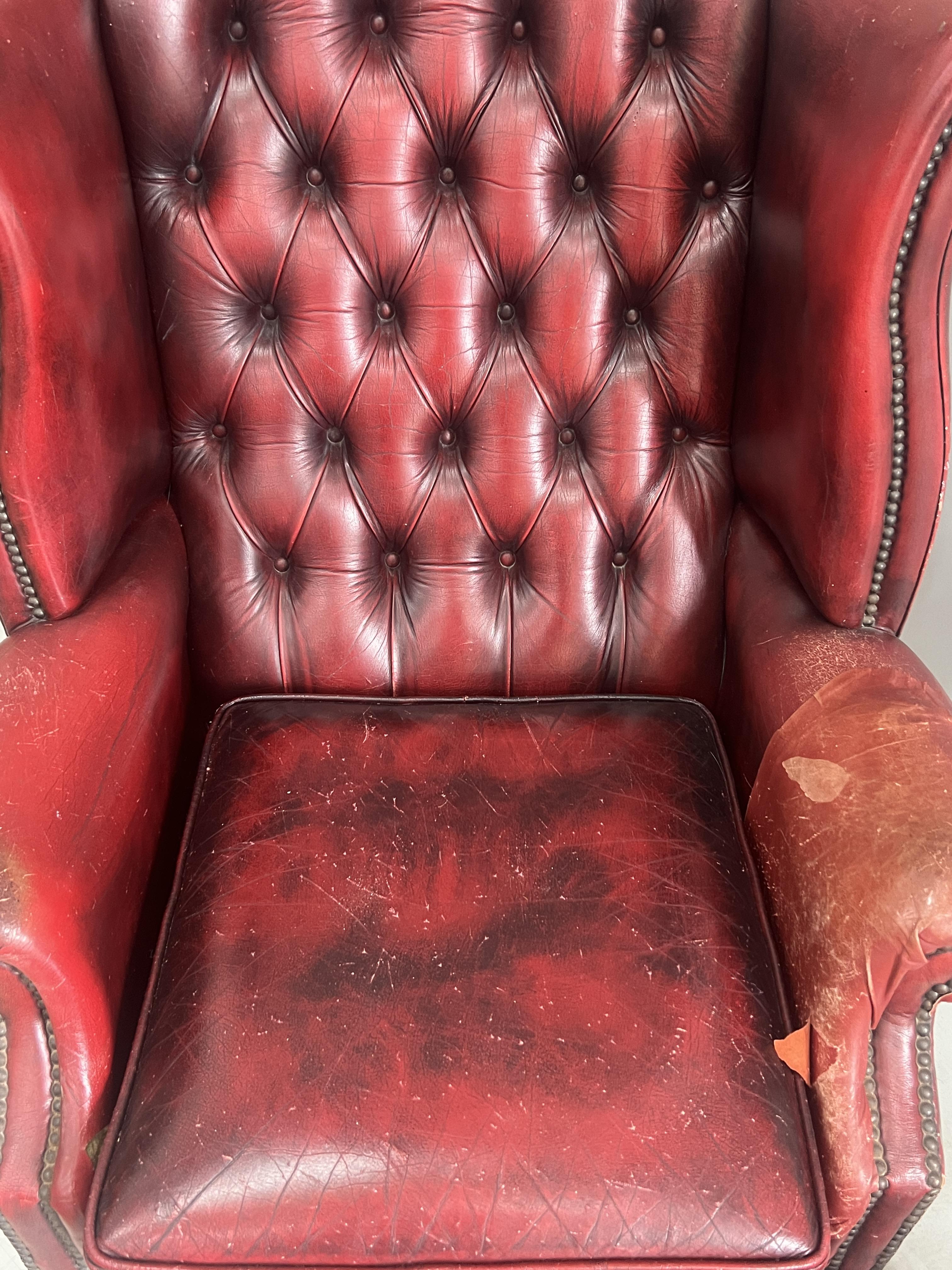 A Victorian style leather armchair, width 82cm, depth 80cm, height 110cm and footstool